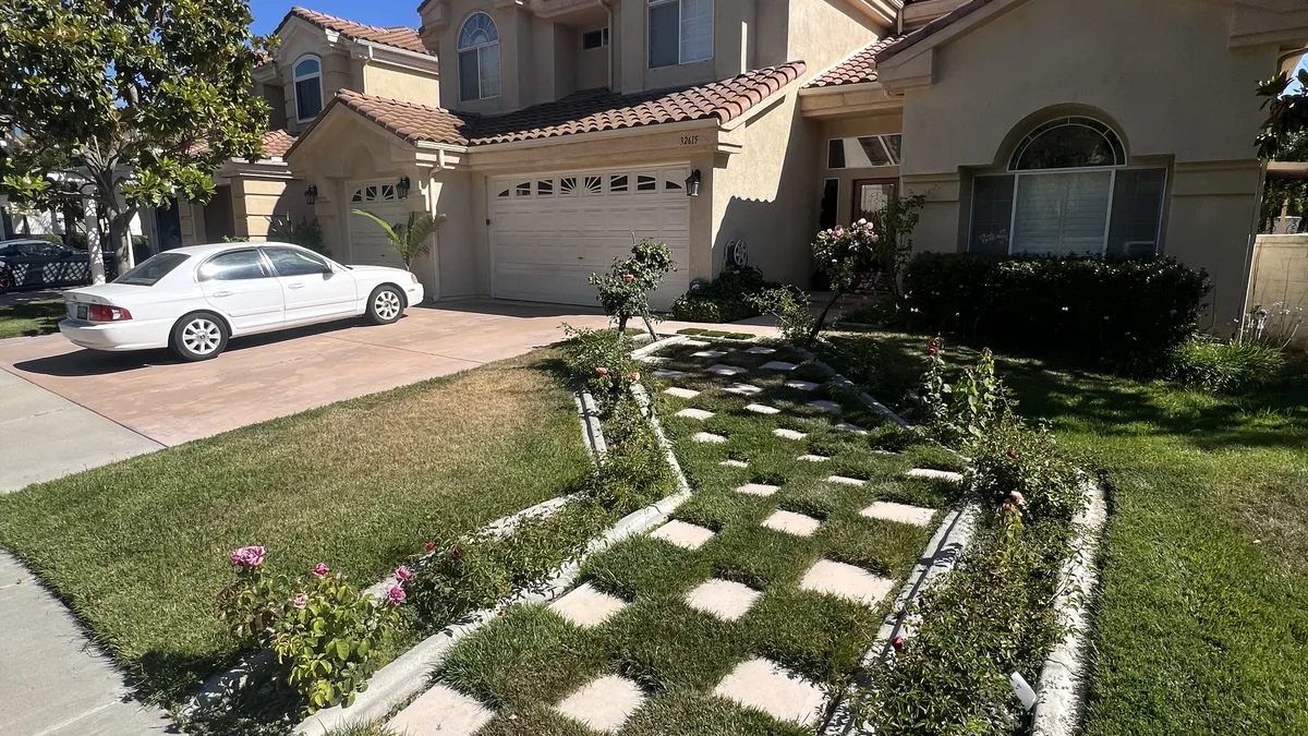 Front entry before: live lawn and pavers, patchy and thirsty
