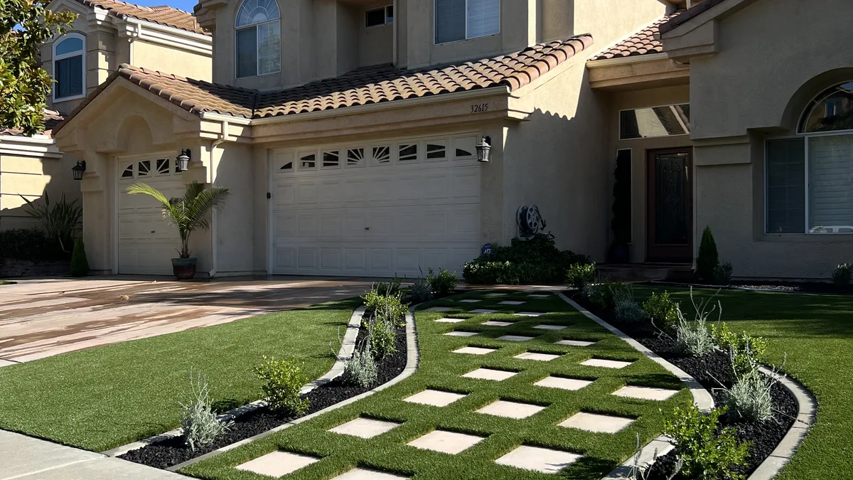 The same entry after: crisp turf-and-paver checkerboard by Scotts Artificial Grass