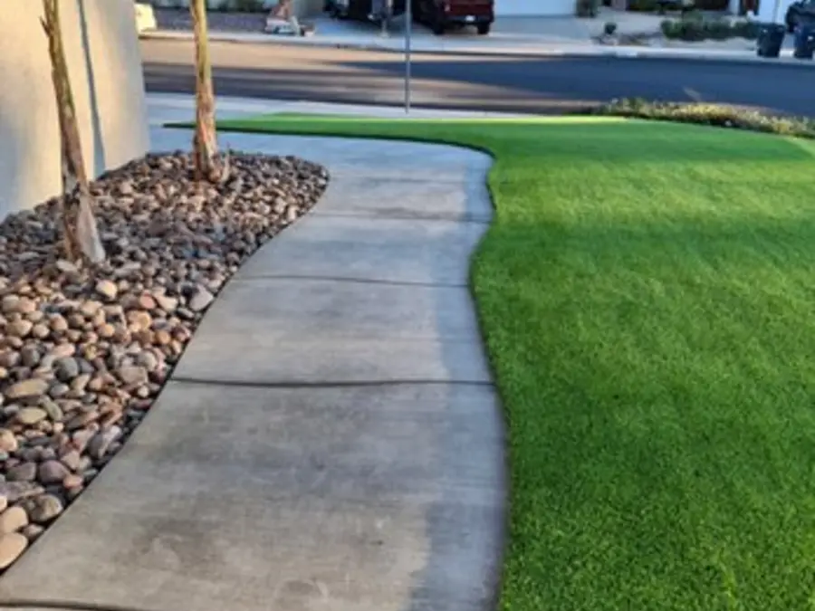 Curved concrete walkway through fresh artificial turf, from this reviewer’s photos